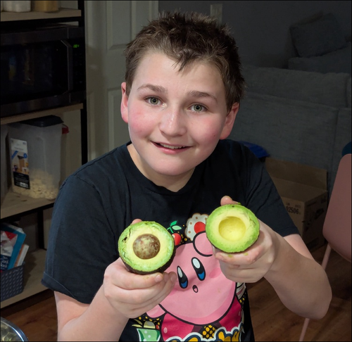 Wyatt holding a perfectly split avocado