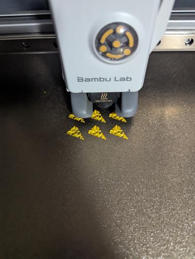 printing a full plate of cheese hats A Bambu Lab Printer is working on the first few layers of cheese hats to be placed on top of keycaps.