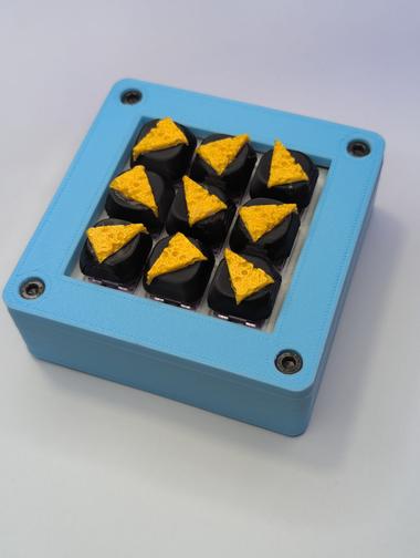 A full Cheese Board A macropad filled with cheese keycaps placed in random orientations.