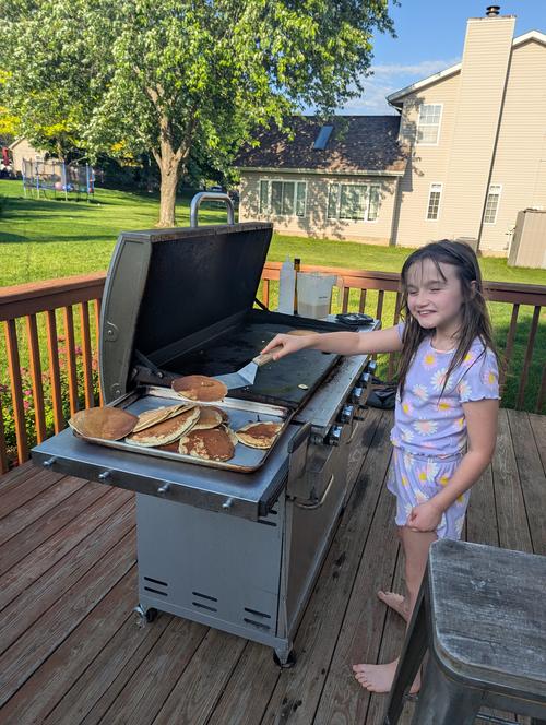 Ayla Making Pancakes on the grill in PJs