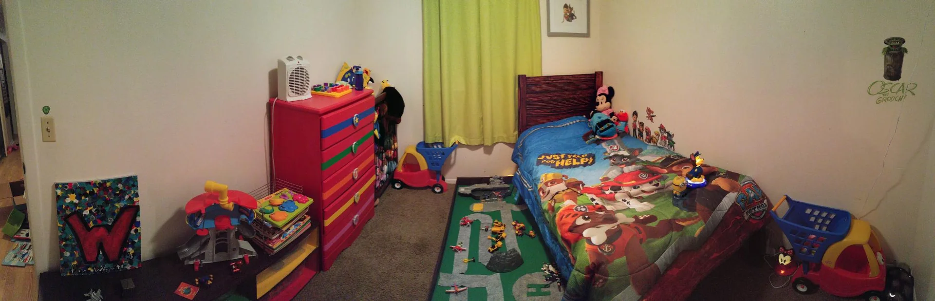 Child’s bedroom with a red dresser and colorful bedding