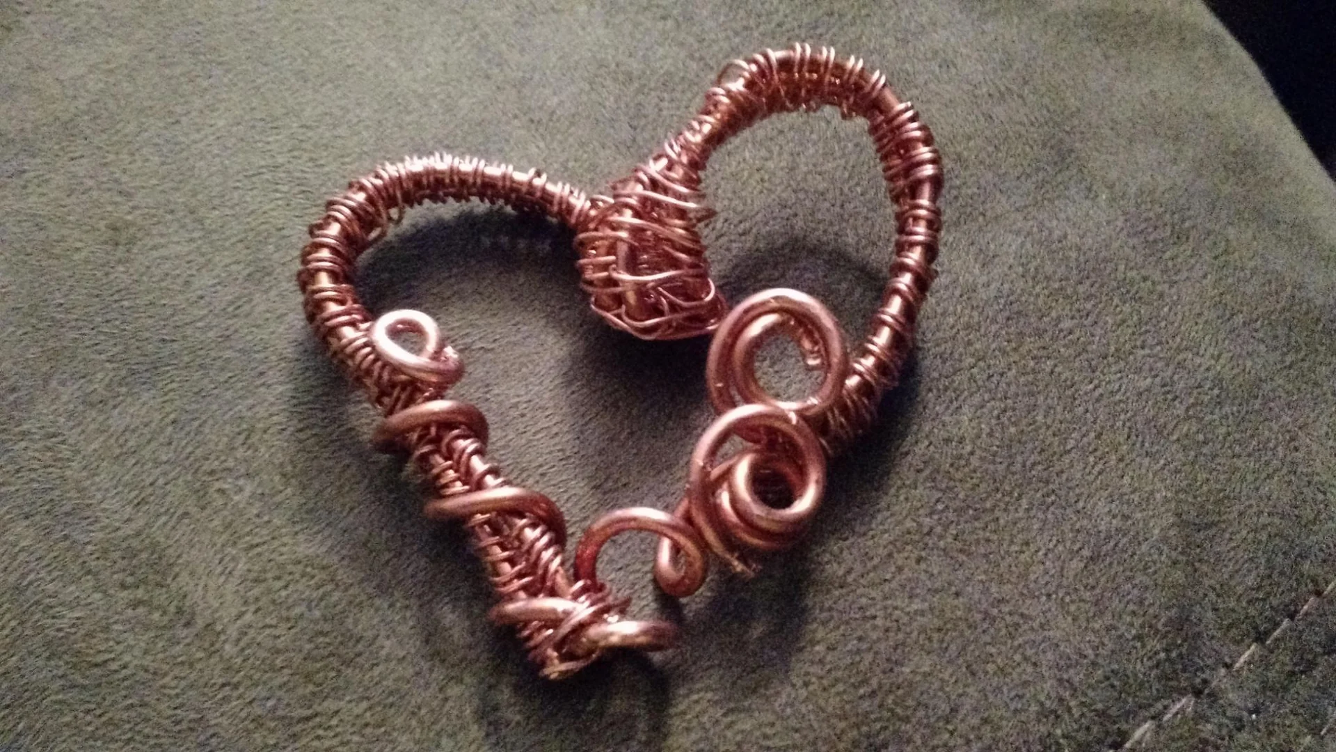 Copper wire pendant bent into a heart