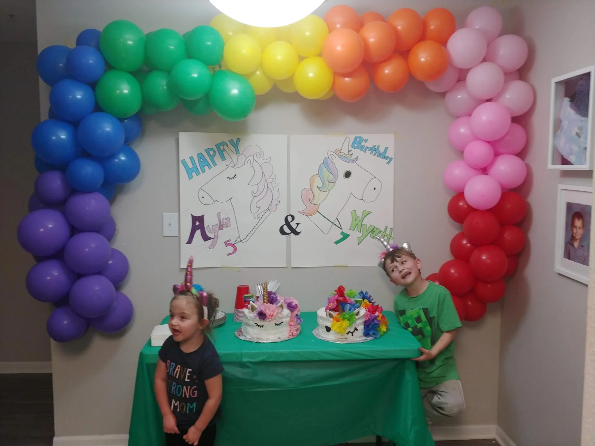 Rainbow balloon arch above a birthday party table