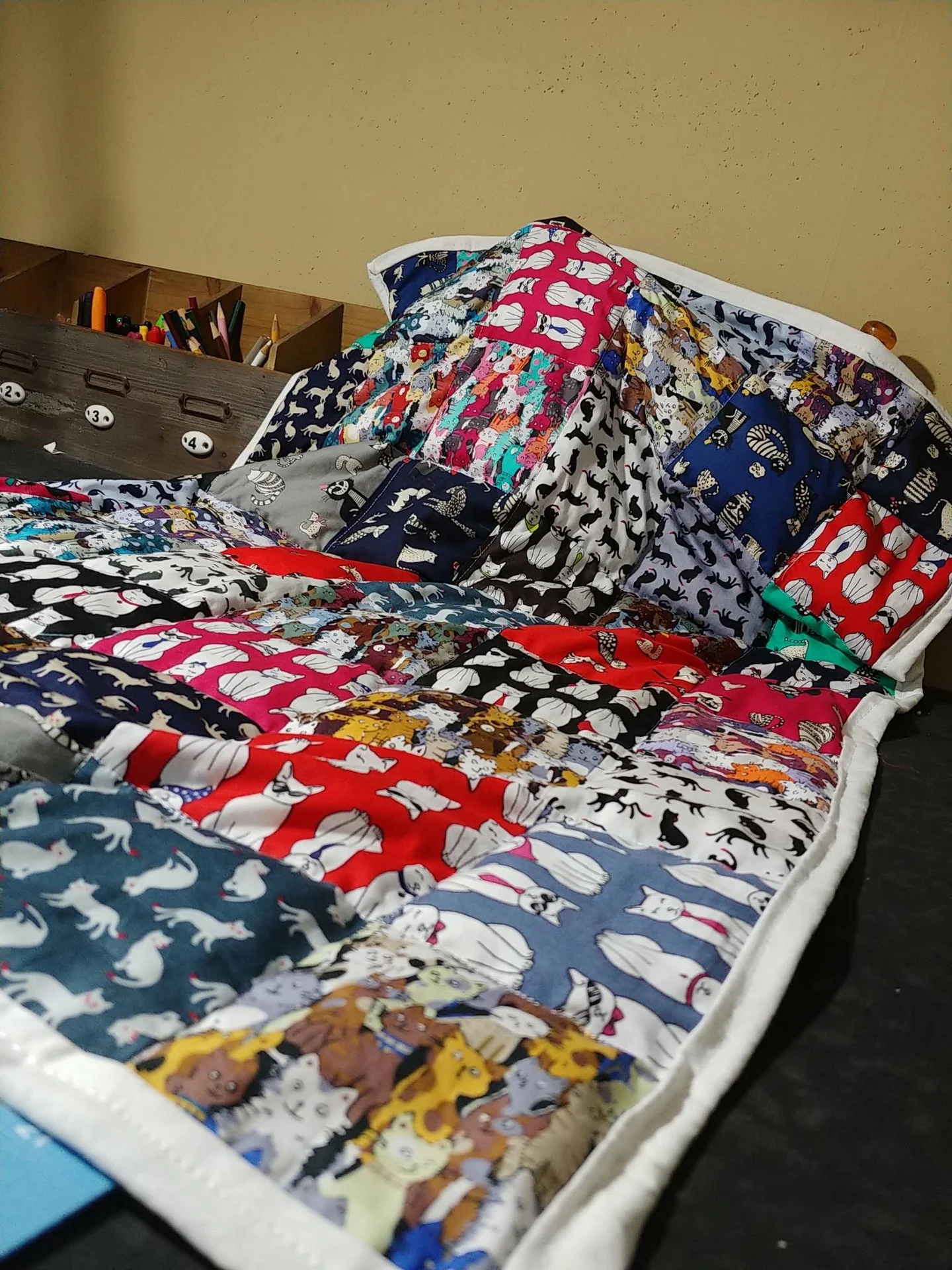 Red, white, and blue patchwork quilt on a bed