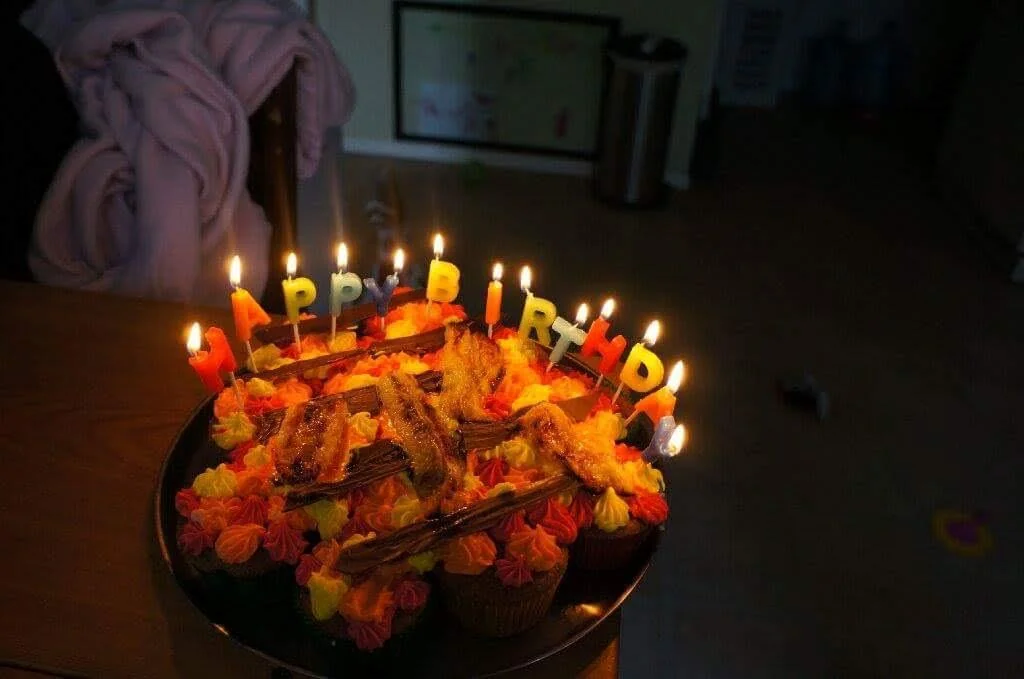 Birthday cake glowing with lit letter candles