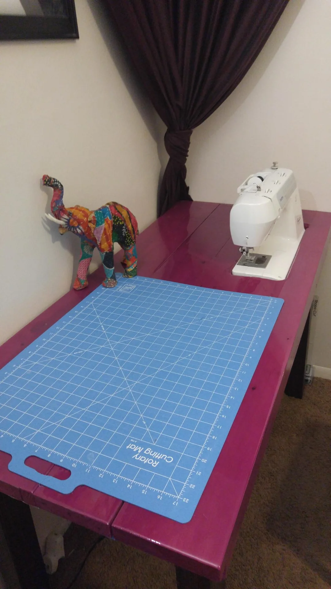 Pink sewing table with a blue cutting mat