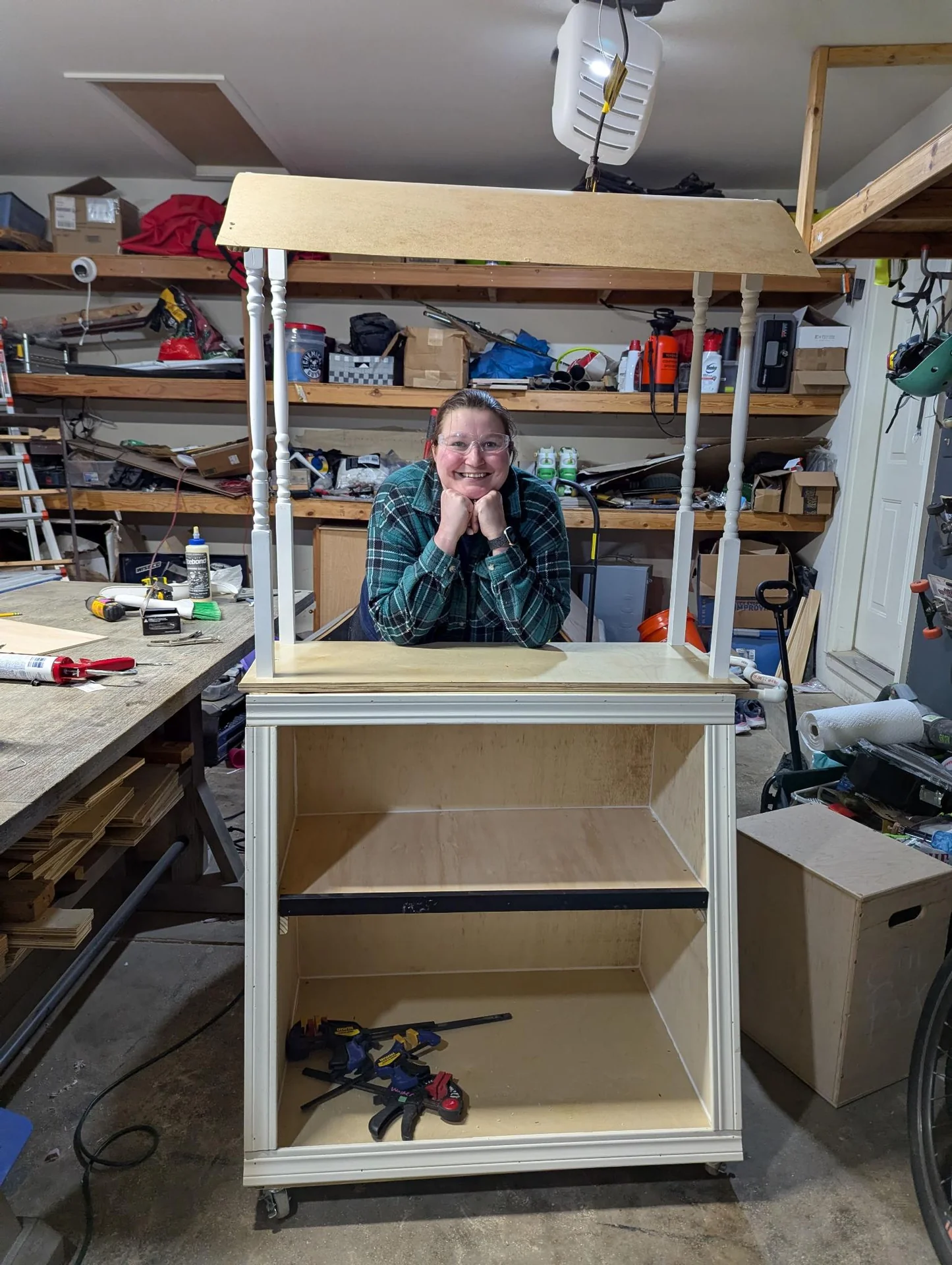Person behind a partly built white cabinet