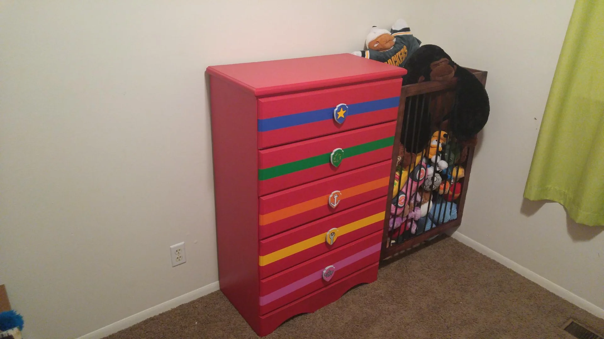 Red dresser with multicolored drawer fronts