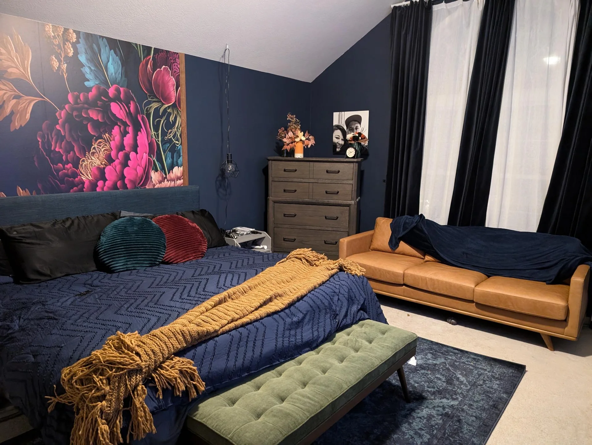 Bedroom with large floral art on a dark wall