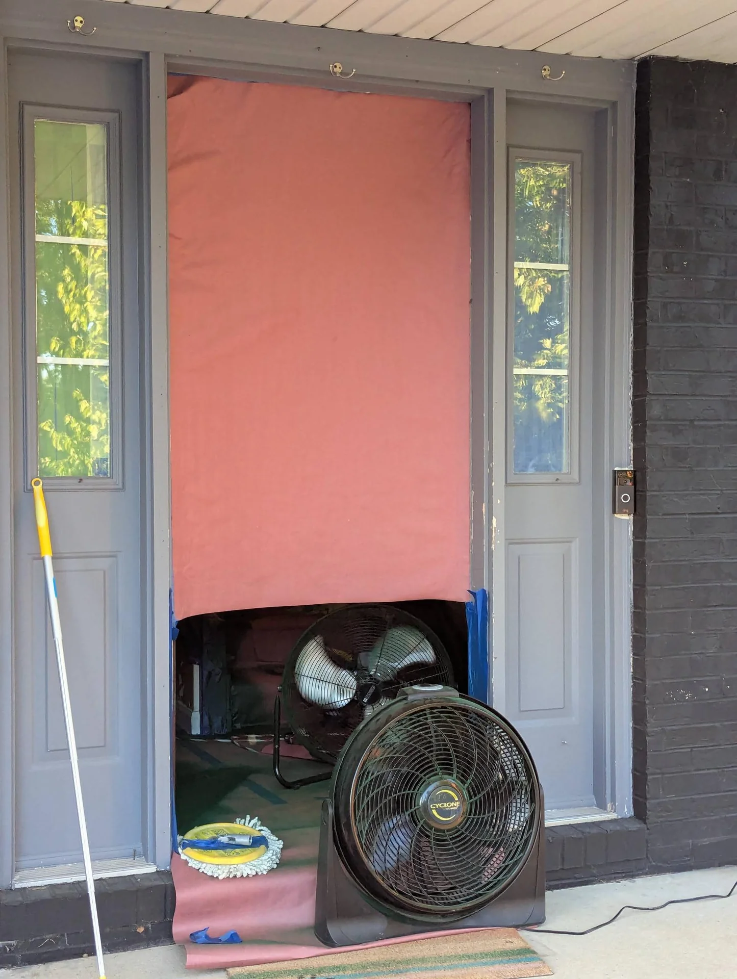 Pink covering over a doorway between narrow windows