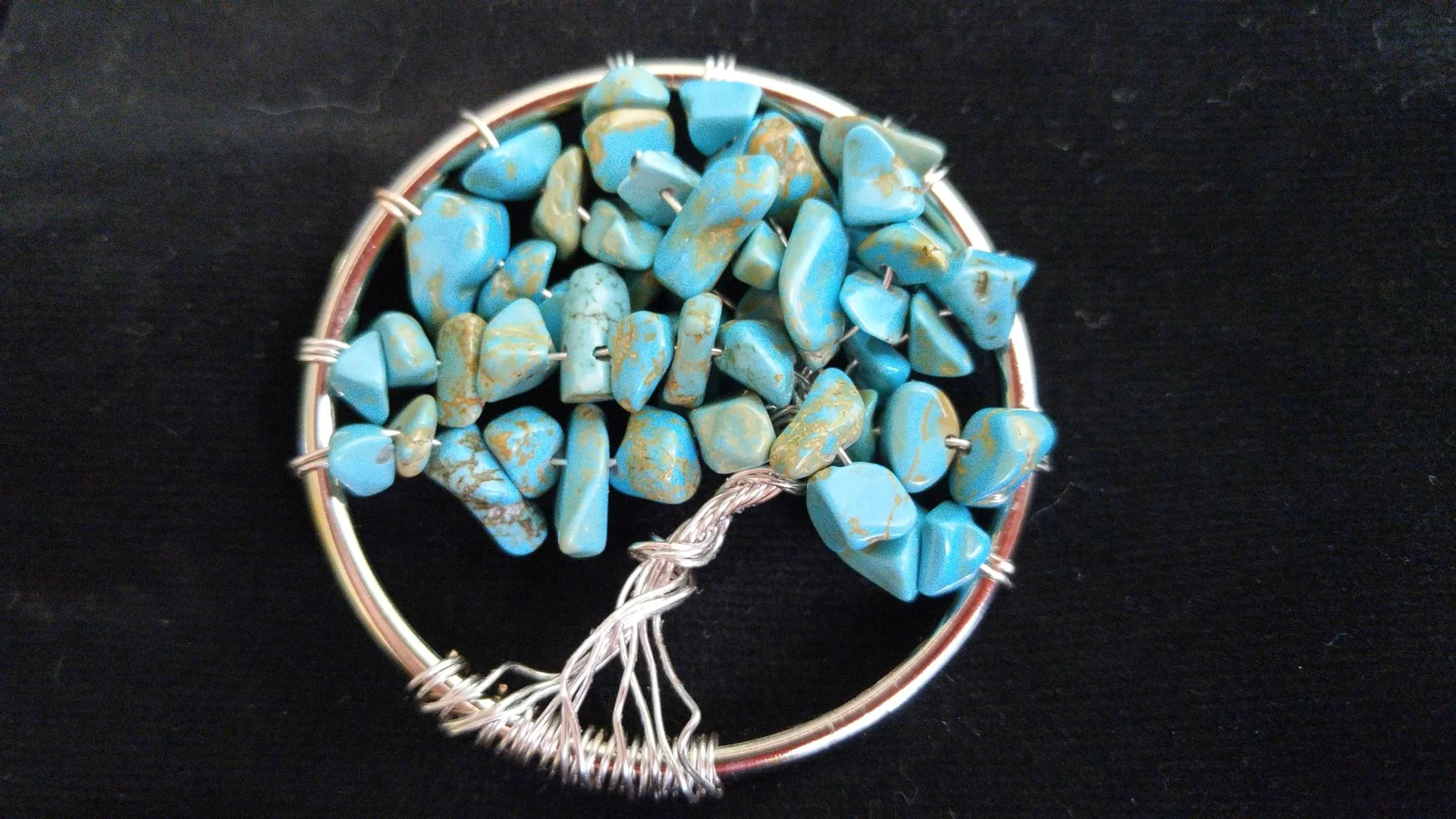 Round tree pendant with turquoise-colored stones
