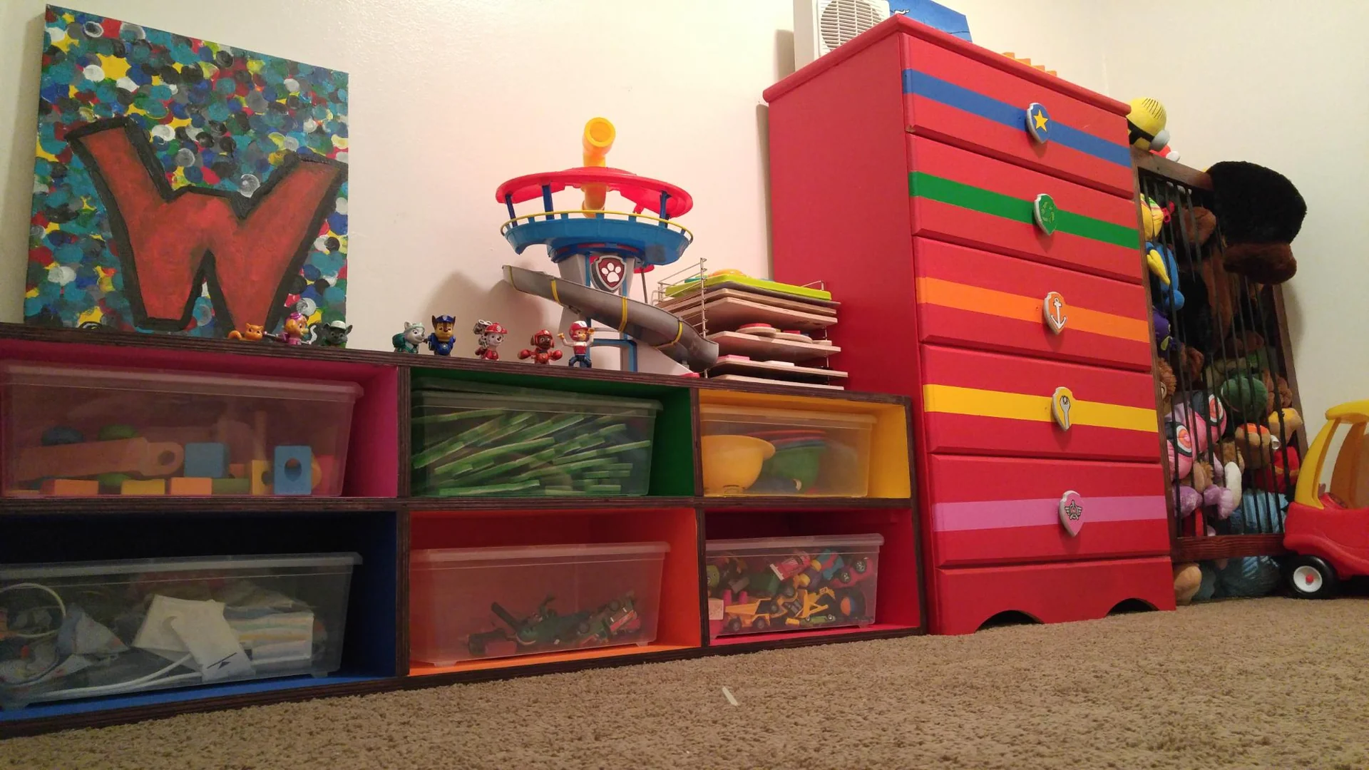 Red dresser with drawers painted in bright stripes