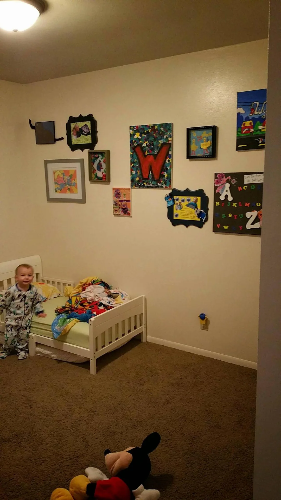 Child’s room with framed art above a small bed