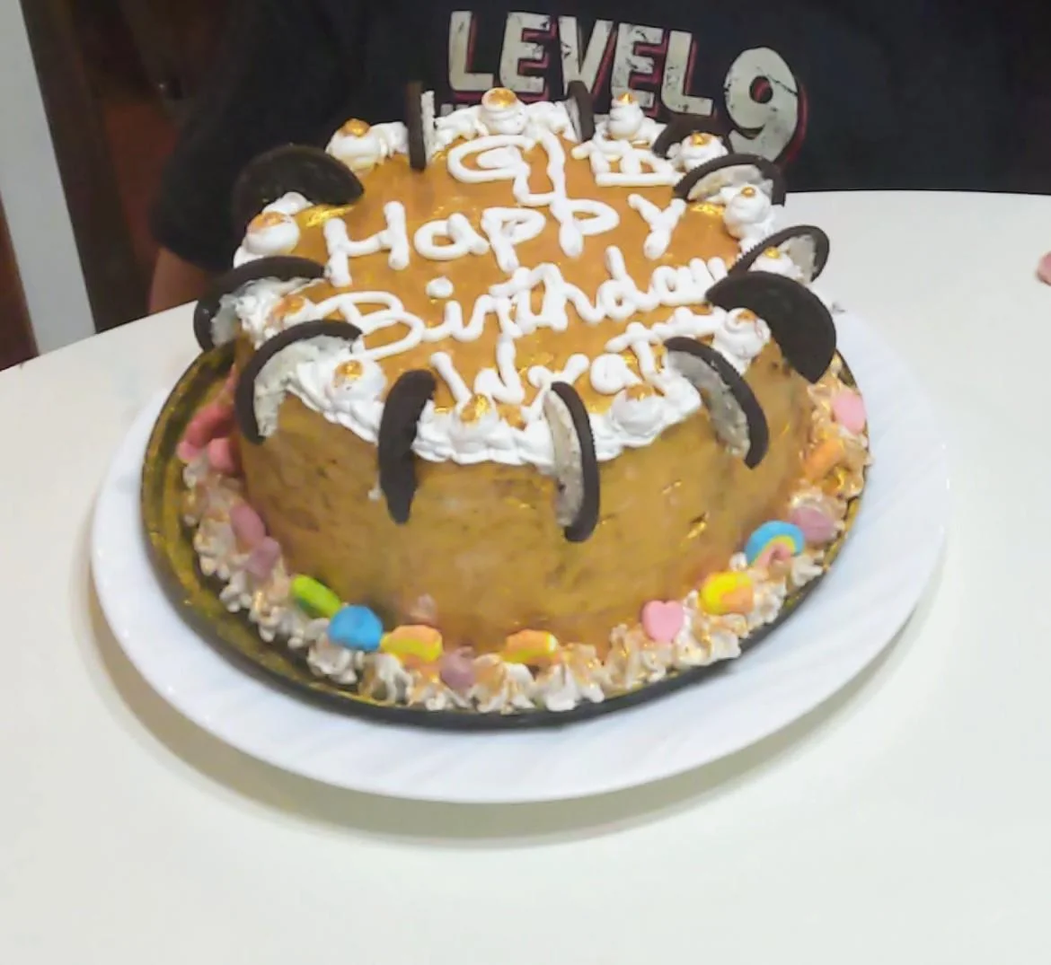 Partly eaten round cake beside a Level 9 sign