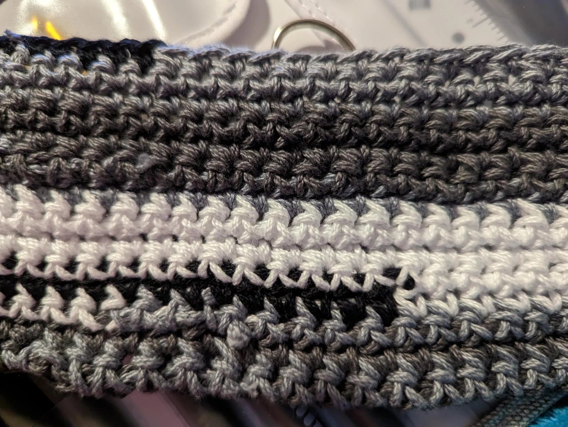 Close view of gray and cream crochet rows