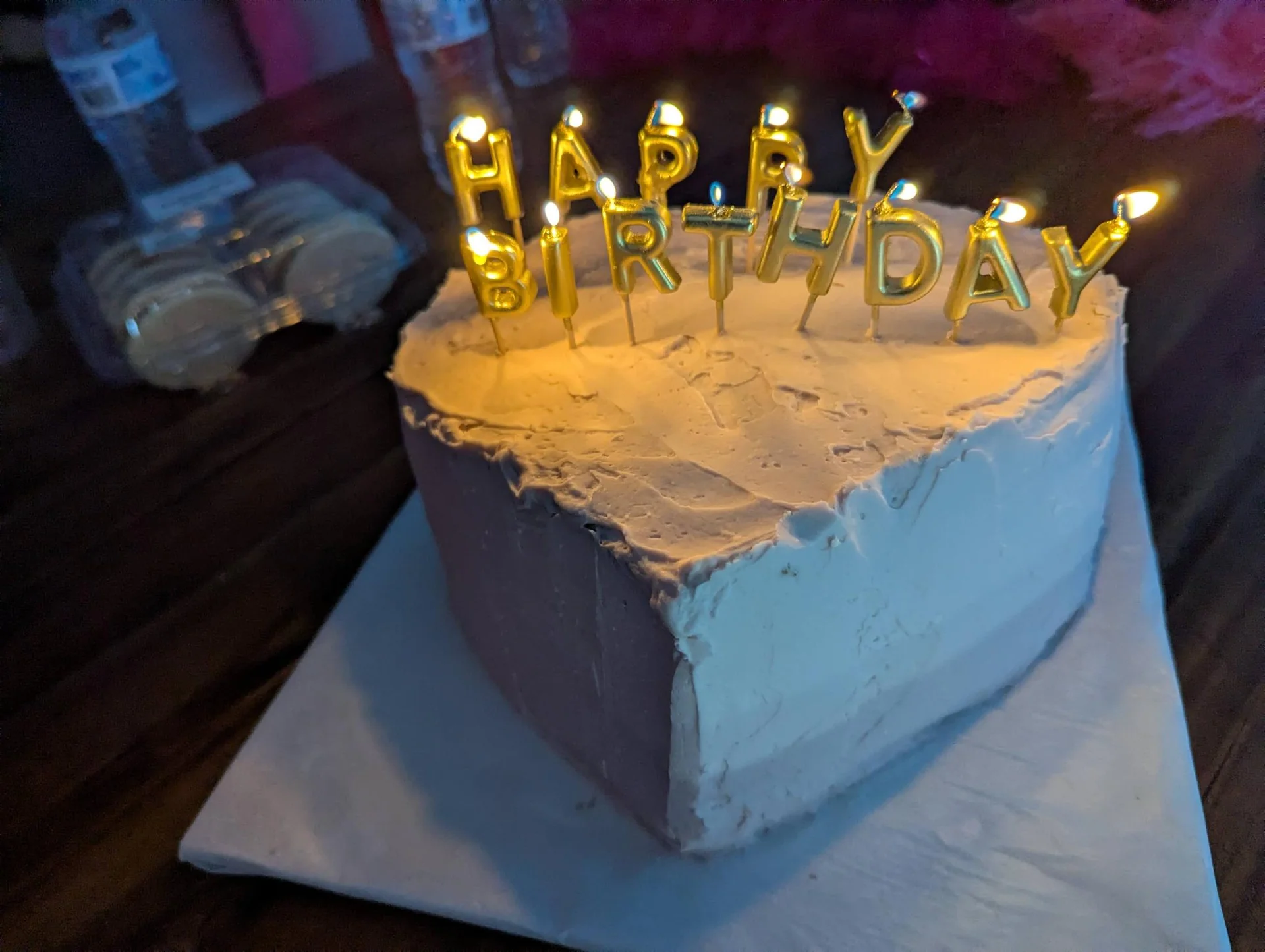 Blue birthday cake topped with gold letter candles