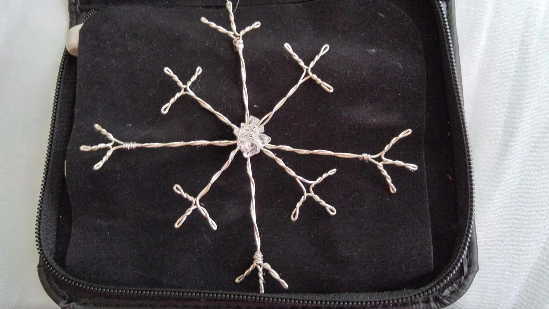 Black pouch with a white embroidered snowflake