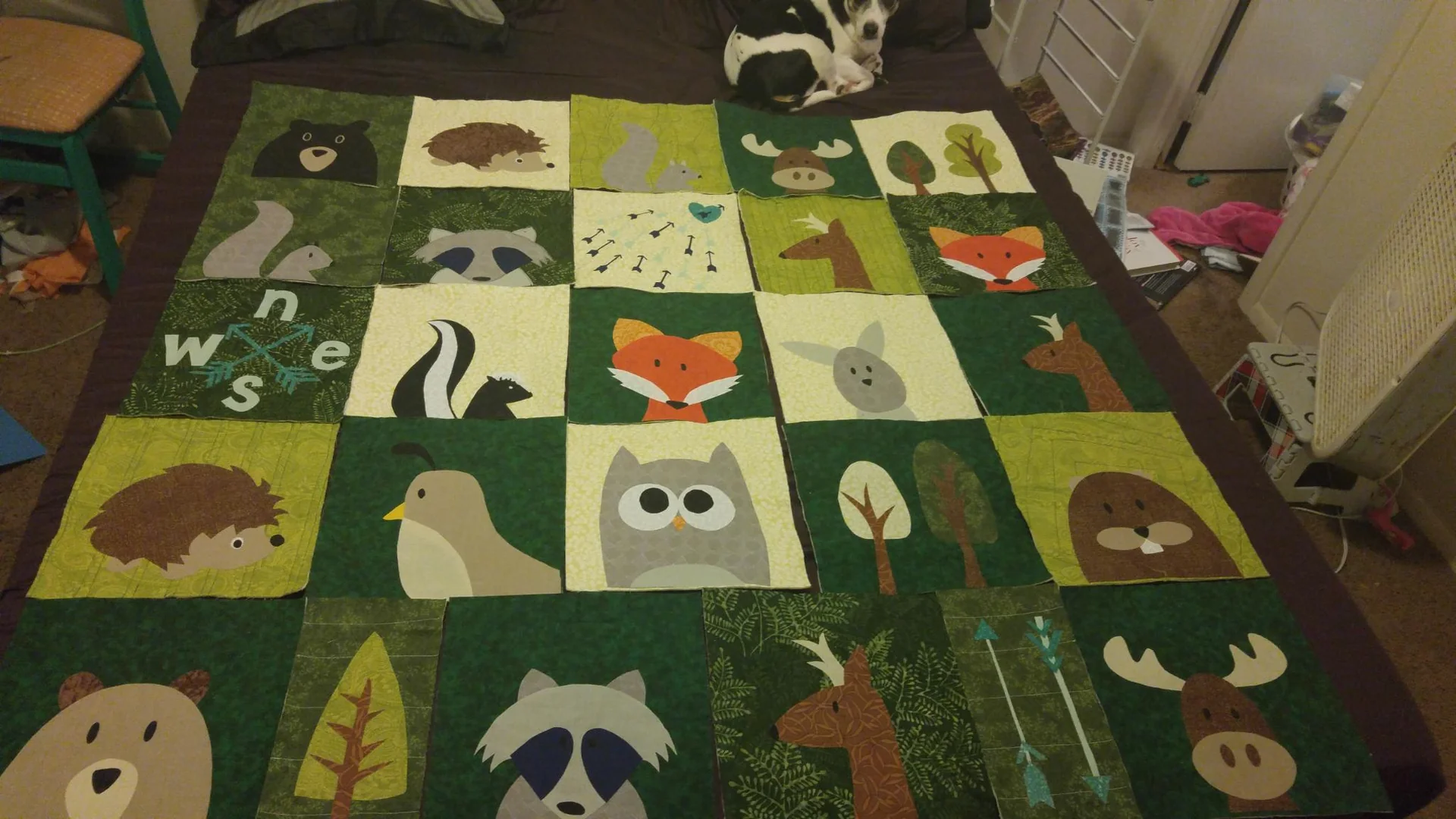 Woodland animal quilt spread over a bed