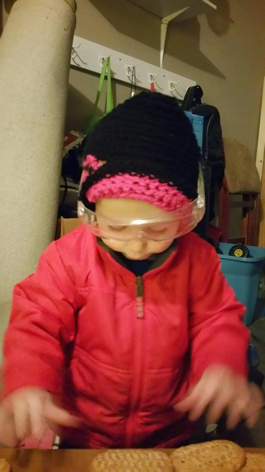 Child wearing a black and pink crocheted hat