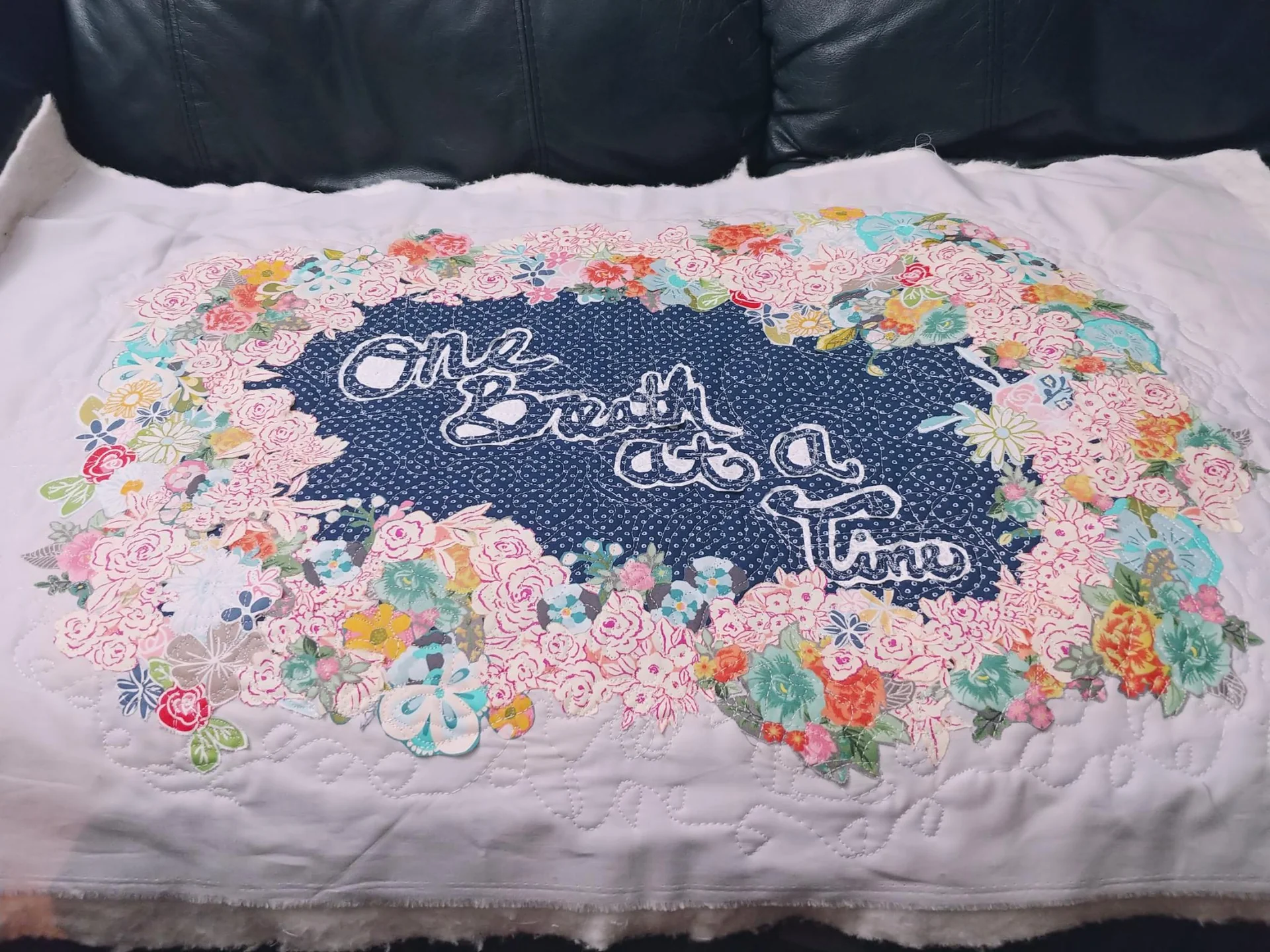 Floral quilt spread across a bed