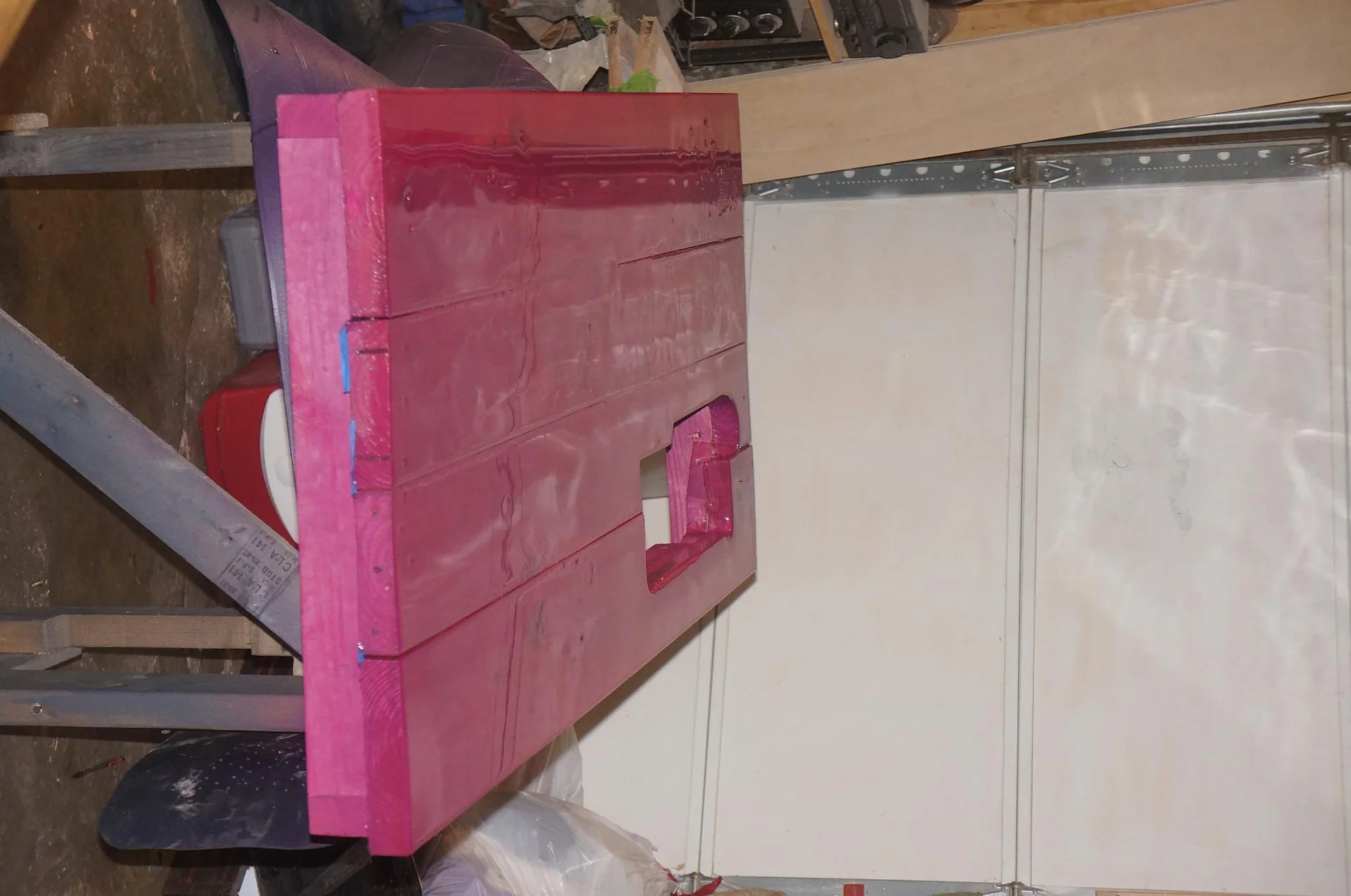 Pink painted wooden furniture panel in a workshop