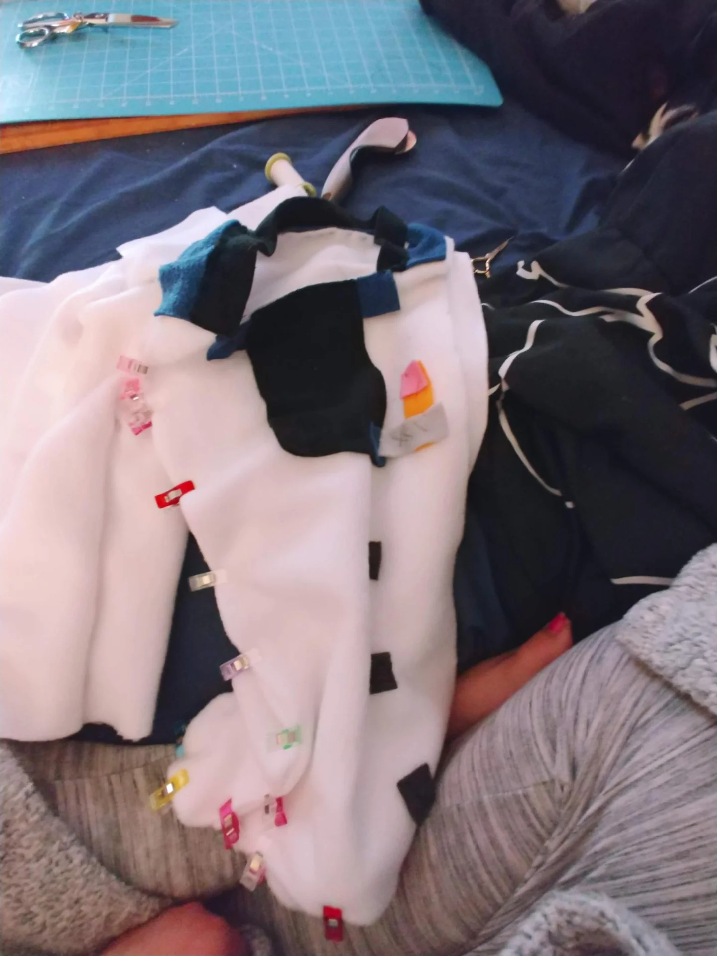 White plush figure being assembled with pins
