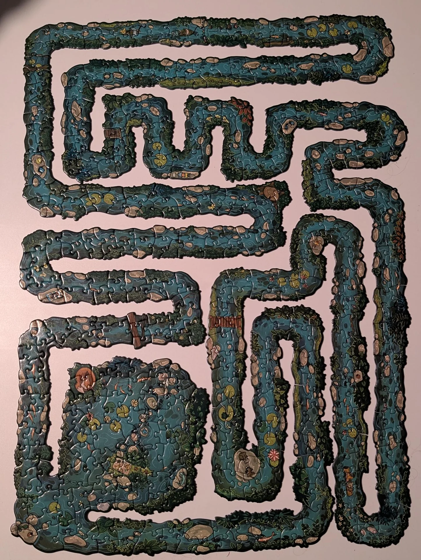 Maze-shaped jigsaw puzzle on a white surface