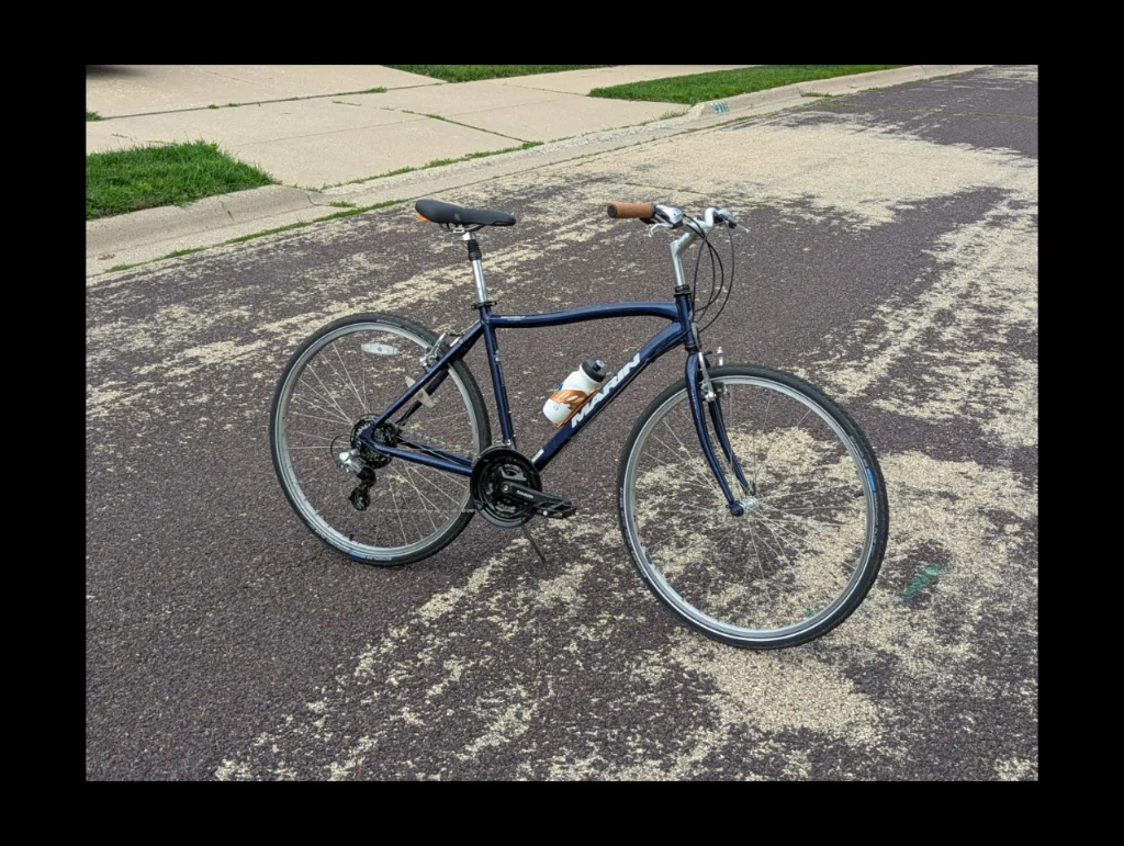 Blue bicycle parked on pavement