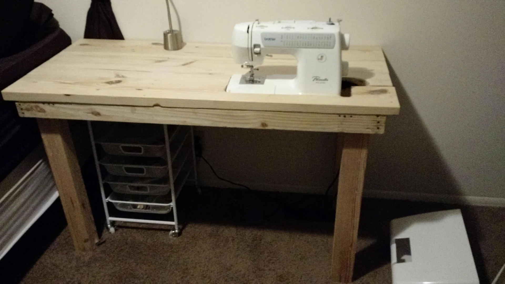 Wooden sewing table with a machine set into its top