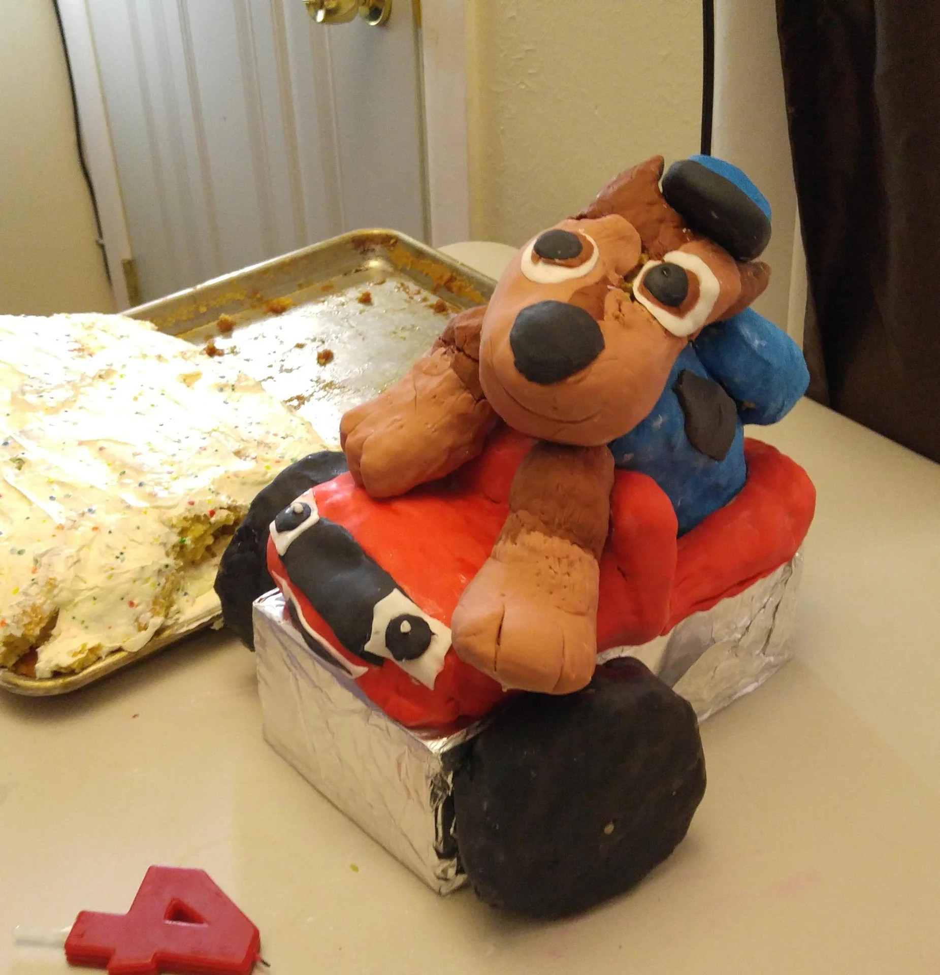 Dog figure decorating the top of a birthday cake