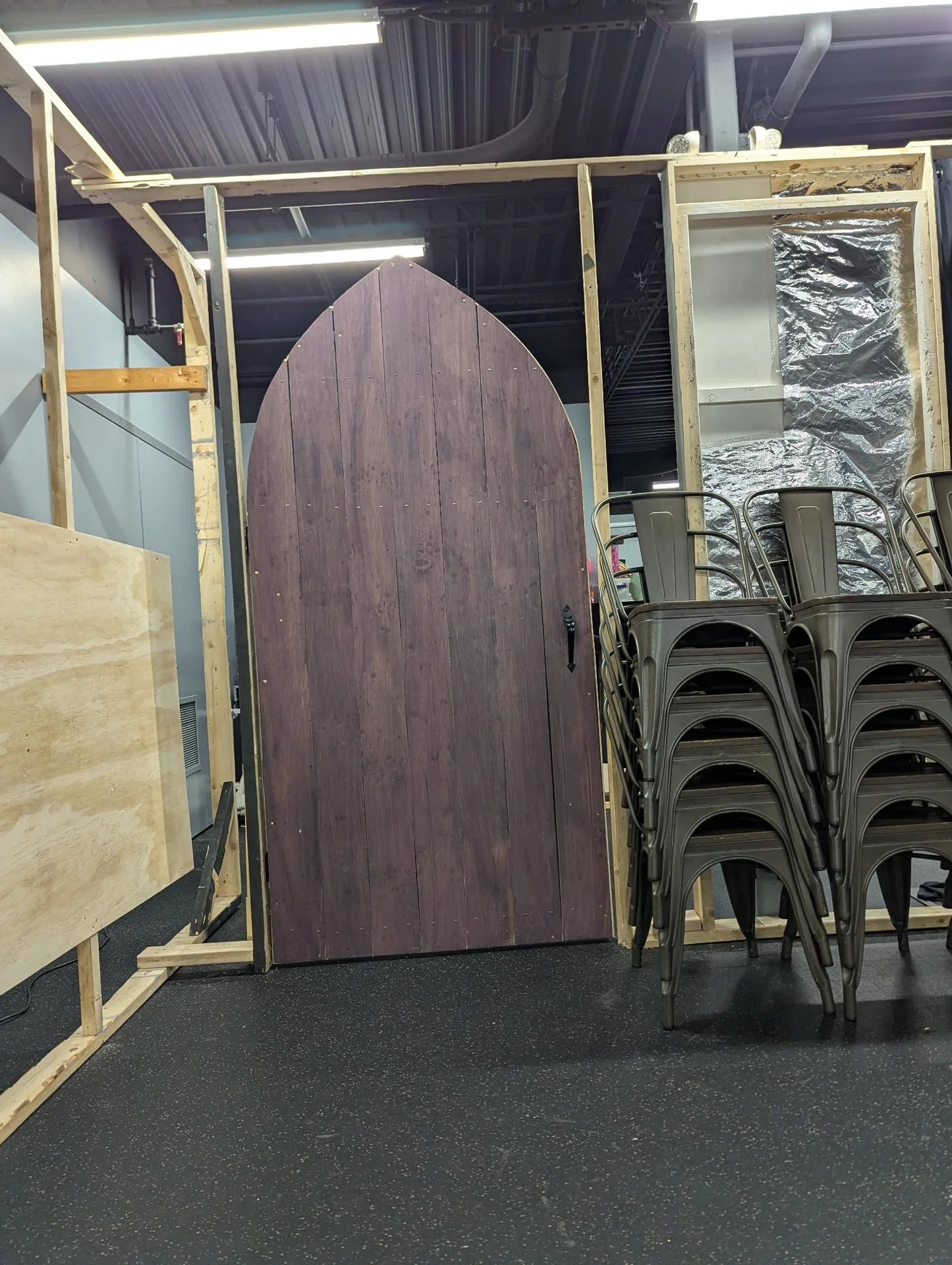 Arched purple door panel inside a wooden stage frame