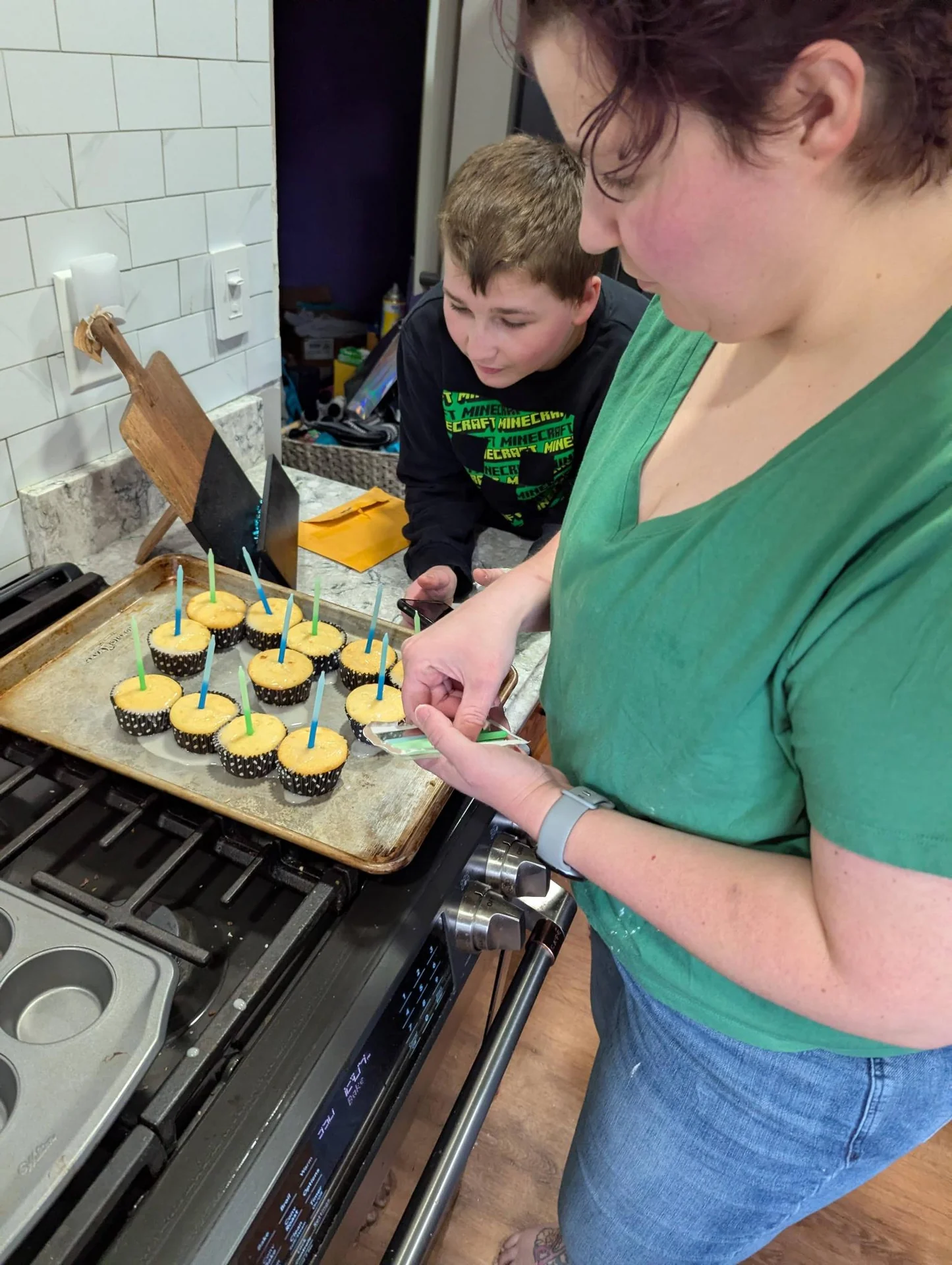 Adult and child decorating cupcakes together