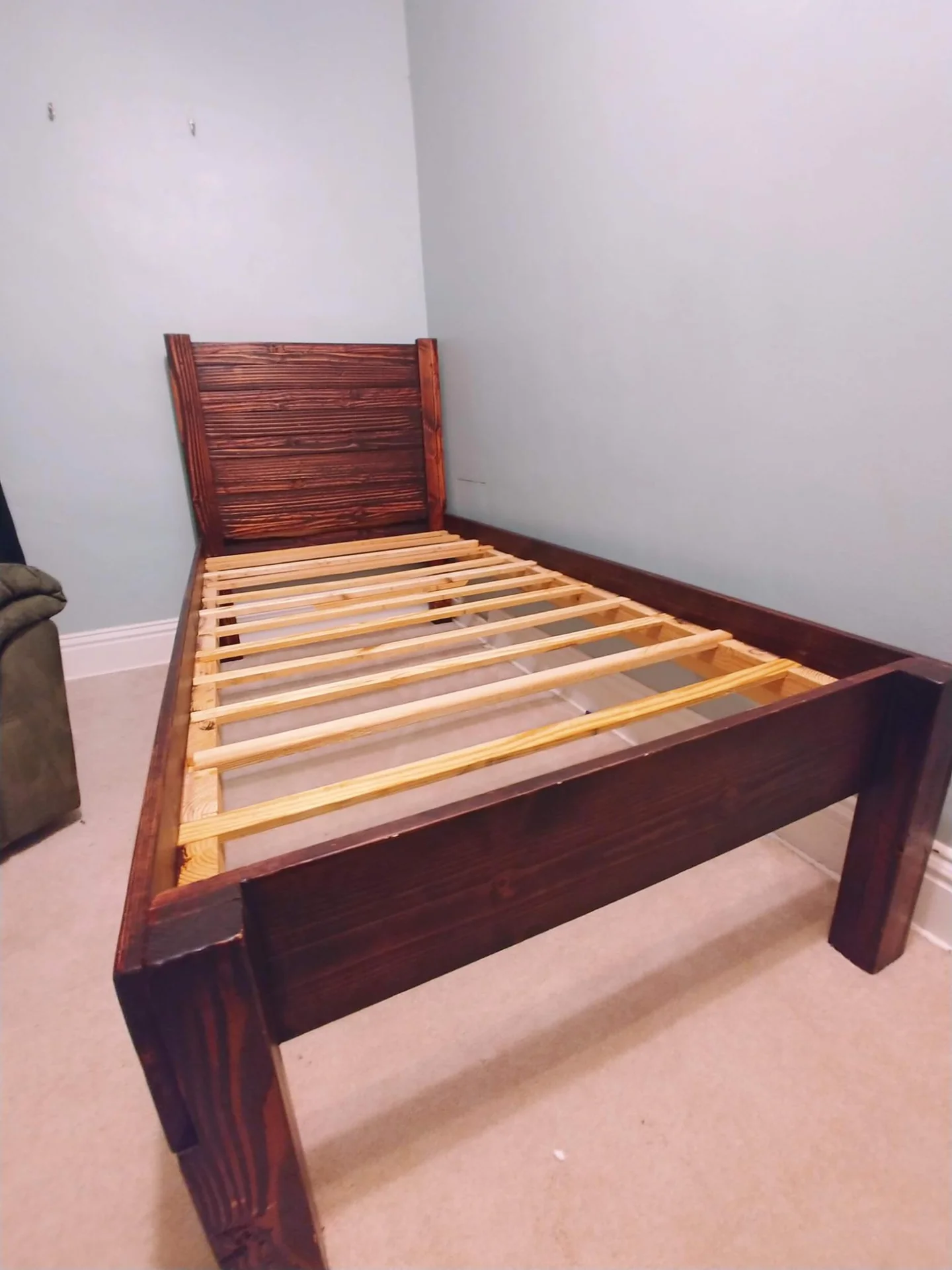 Wooden bed frame with exposed slats