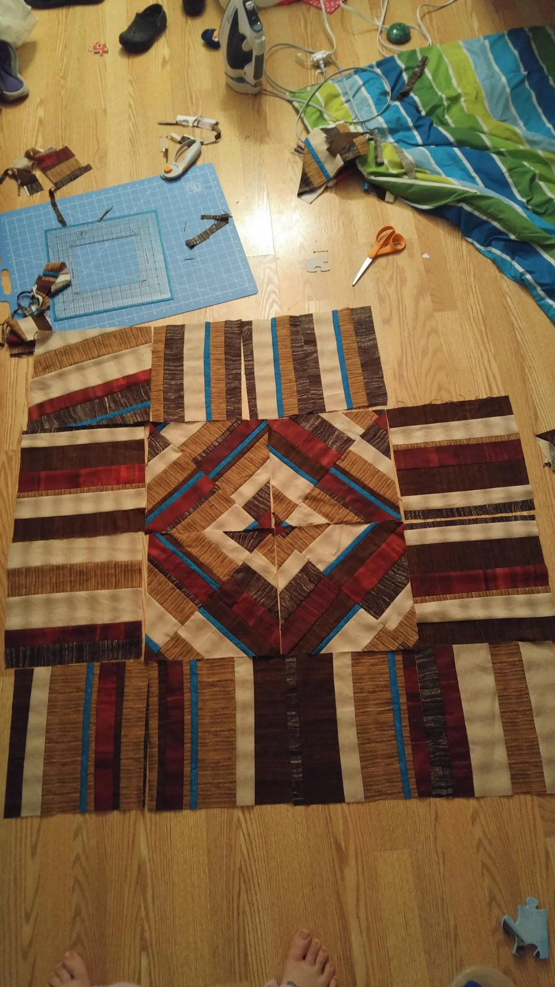 Geometric patchwork quilt laid out on a worktable