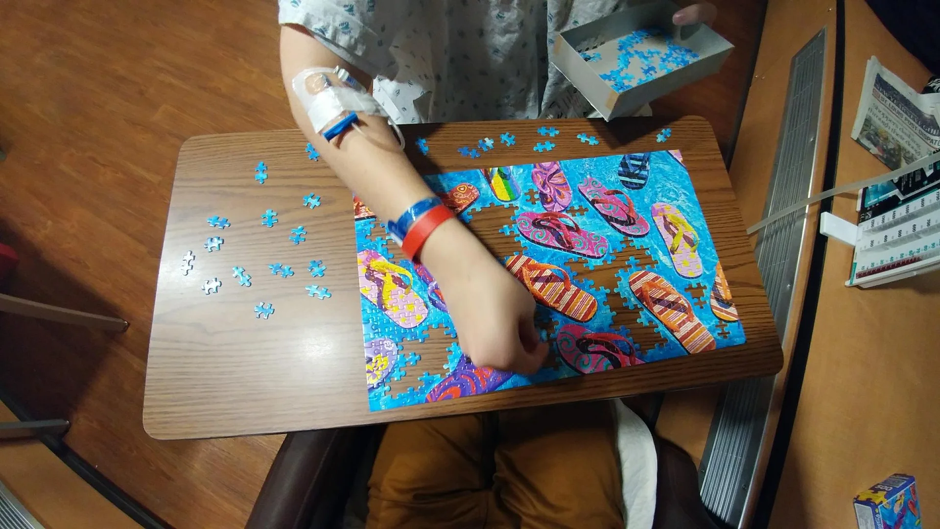 Person placing pieces in a bright jigsaw puzzle